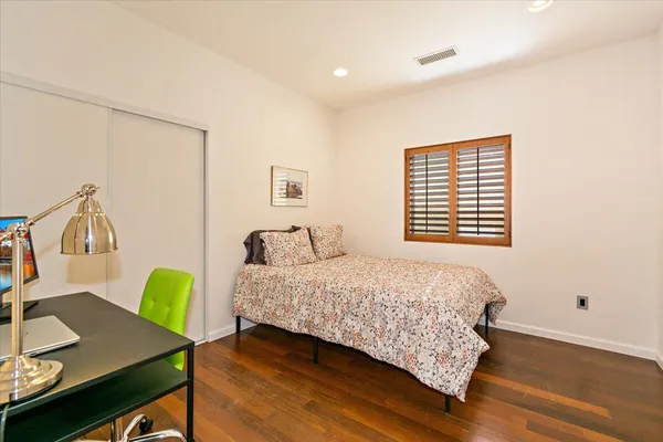 a bedroom with a bed and a desk