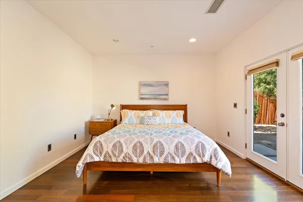 a bed sitting in a bedroom next to a window