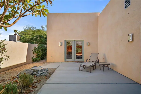 a view of a chairs and table in the back yard