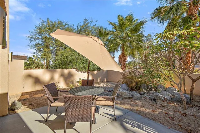 a view of a chairs and table in the patio