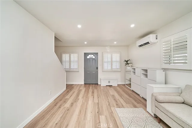 a view of a living room hardwood floor and a ceiling fan