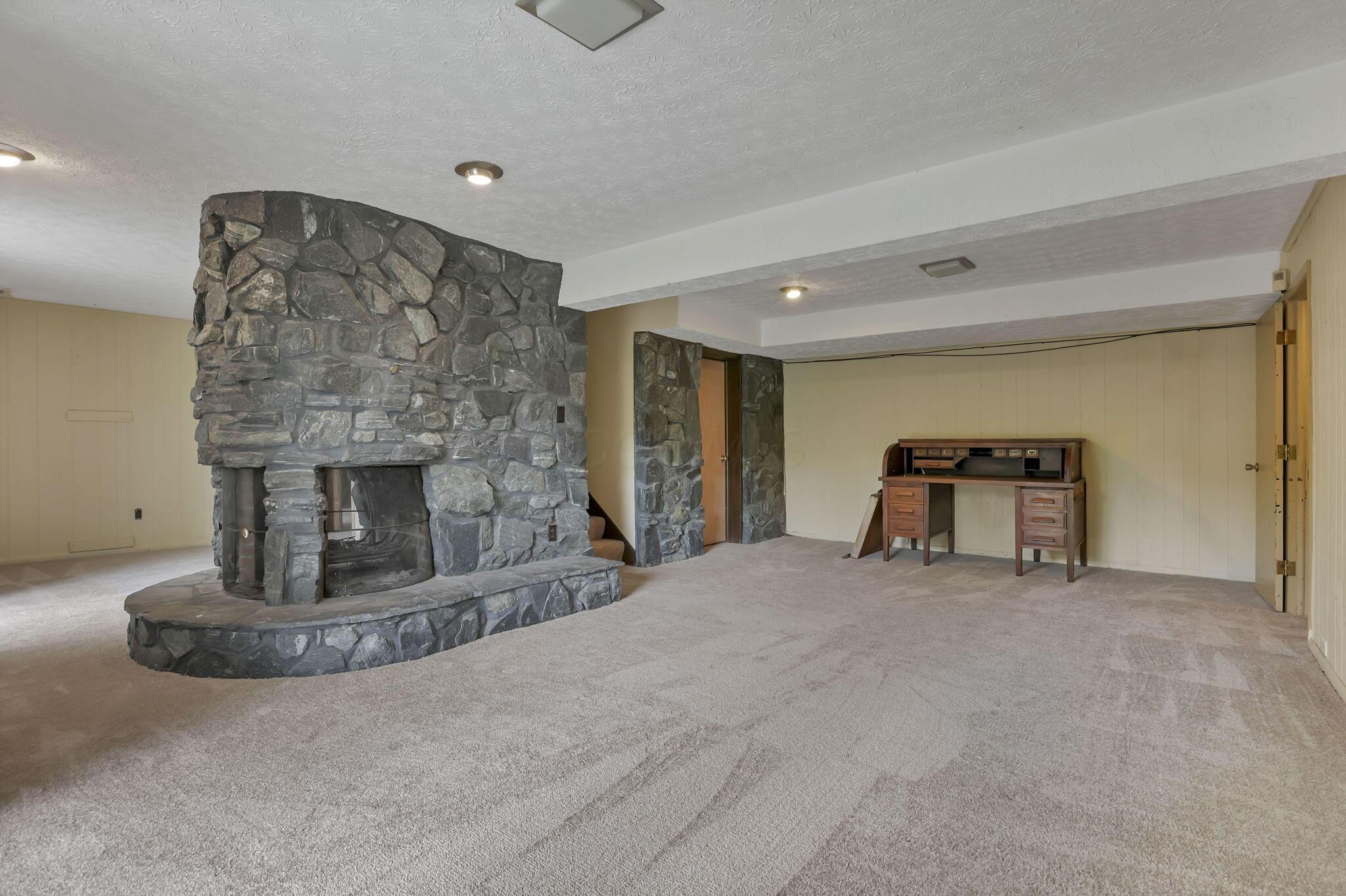 7766 Rodebaugh Road Reynoldsburg, OH 43068 - Photo 32 of 59 Lower level family room w/stone fireplace