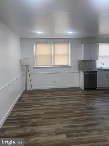a kitchen with granite countertop a sink stainless steel appliances and cabinets
