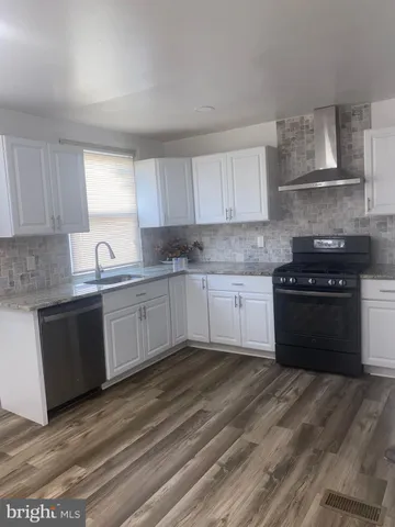 a kitchen with a stove a sink and a refrigerator