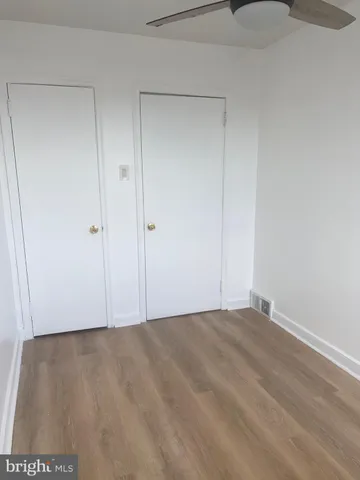 a view of hallway with wooden floor