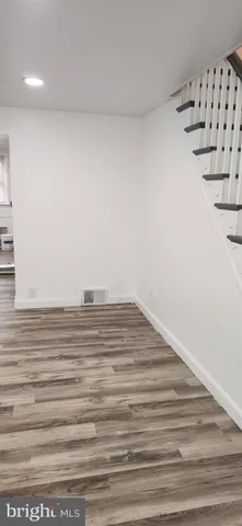 a view of a room with wooden floor and staircase