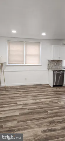 a kitchen with stainless steel appliances granite countertop a stove and white cabinets