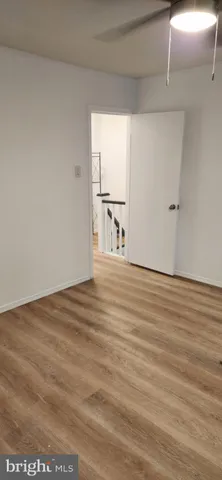 a view of a hallway with wooden shelves