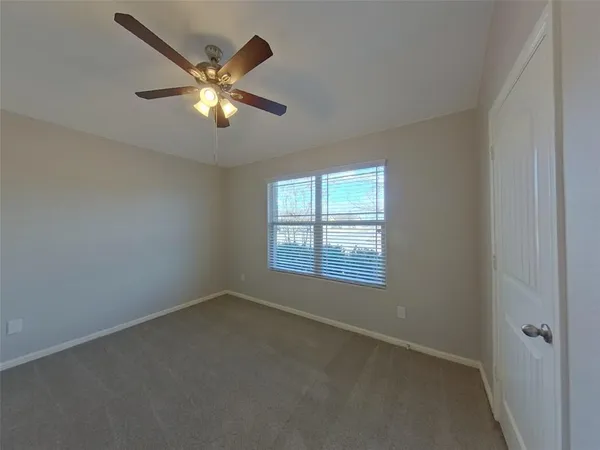 a view of a livingroom with a ceiling fan and window