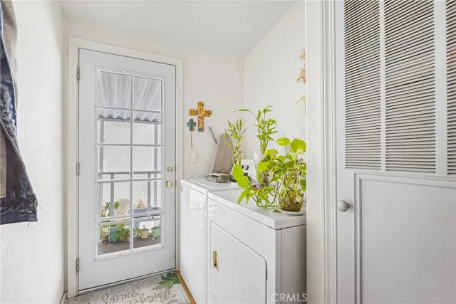 a white painted room with white cabinets and wooden floor