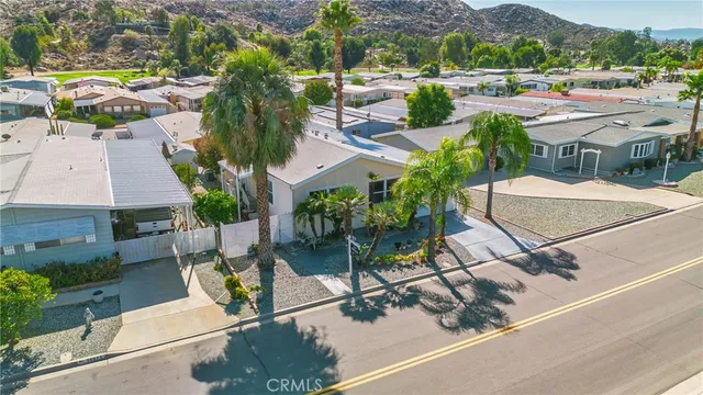 an aerial view of a house with garden space and street view