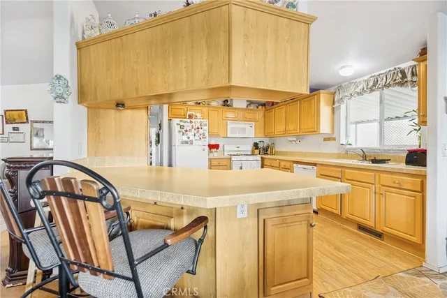 a view of a kitchen with a large window
