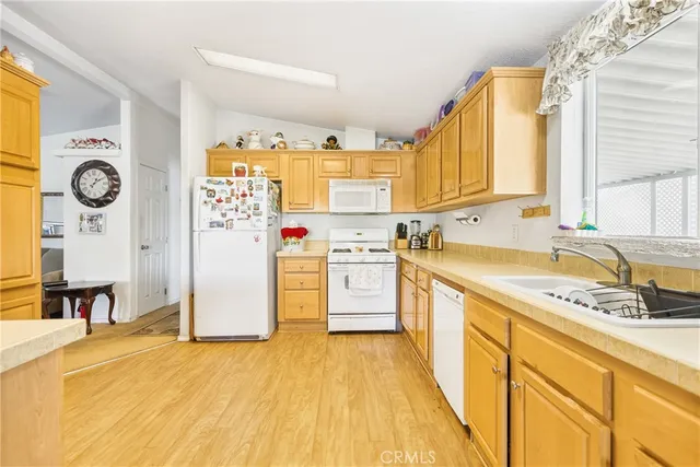 a kitchen with a stove a sink and a refrigerator