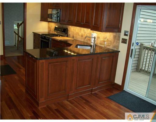 8 Phillips Road Edison, NJ 08817 - Photo 8 of 25 a view of kitchen with wooden floor and cabinets