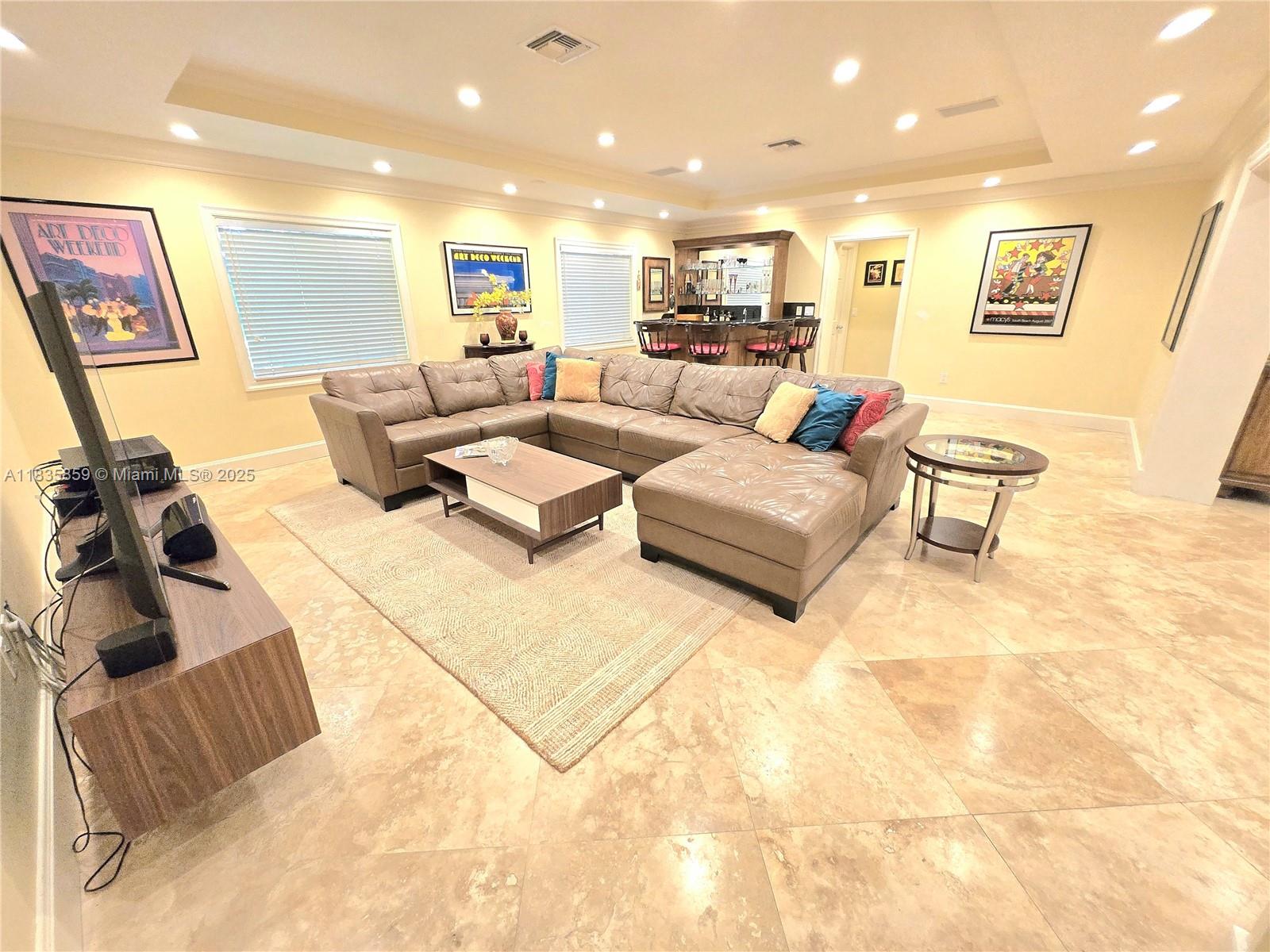 7895 Southwest 122nd Street Pinecrest, FL 33156 - Photo 12 of 78 a living room with furniture and a flat screen tv