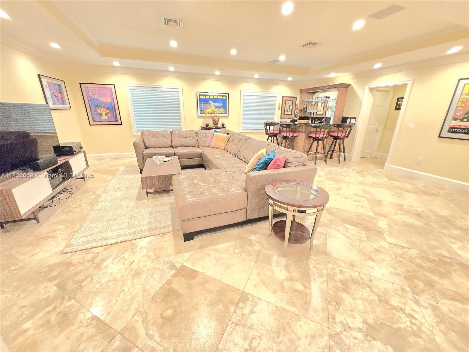 7895 Southwest 122nd Street Pinecrest, FL 33156 - Photo 13 of 78 a living room with furniture and a dining table with kitchen view