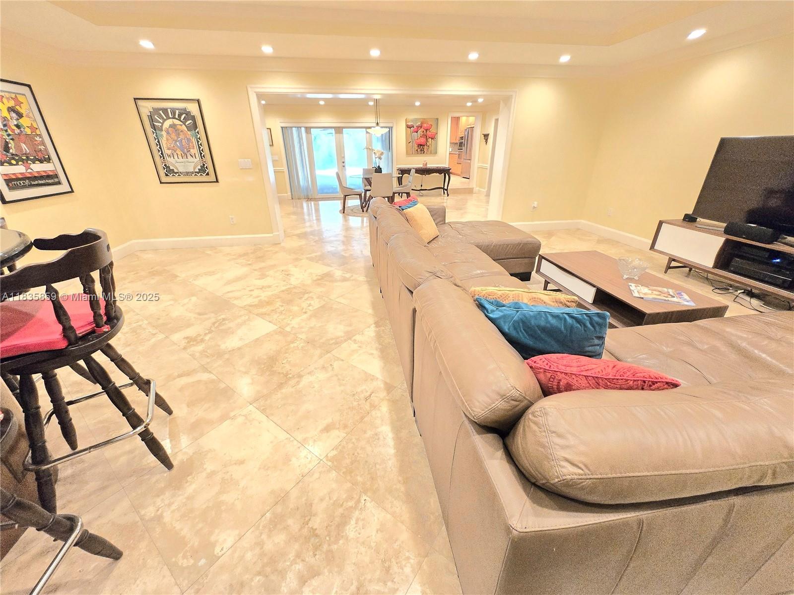 7895 Southwest 122nd Street Pinecrest, FL 33156 - Photo 15 of 78 a living room with furniture and a flat screen tv