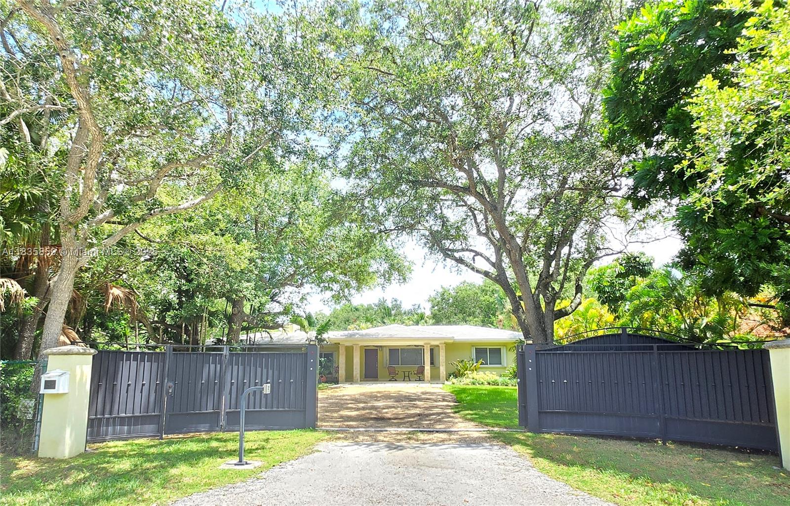 7895 Southwest 122nd Street Pinecrest, FL 33156 - Photo 2 of 78 a view of a house with a yard and a large tree