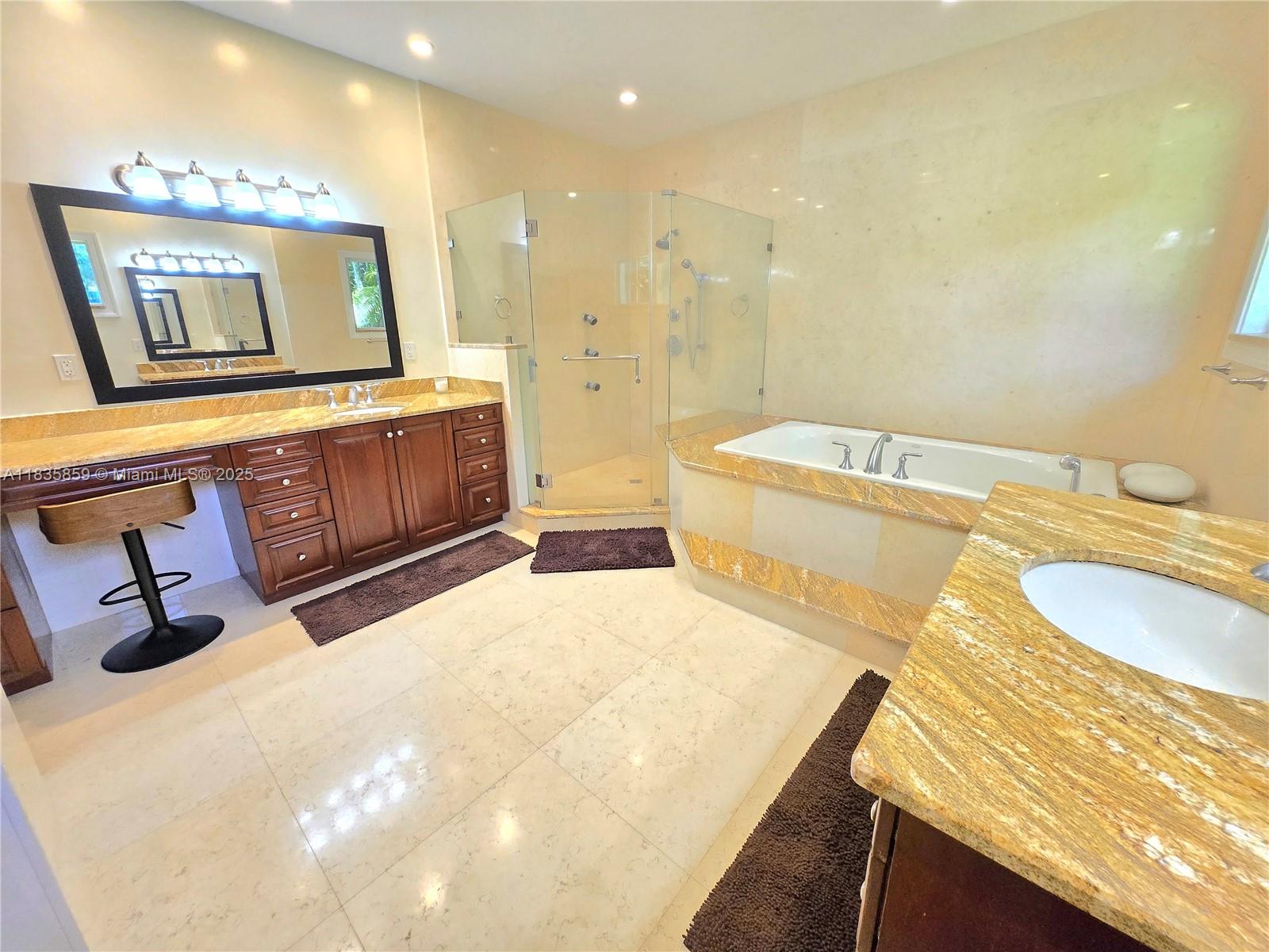 7895 Southwest 122nd Street Pinecrest, FL 33156 - Photo 23 of 78 a bathroom with a sink a vanity and mirror