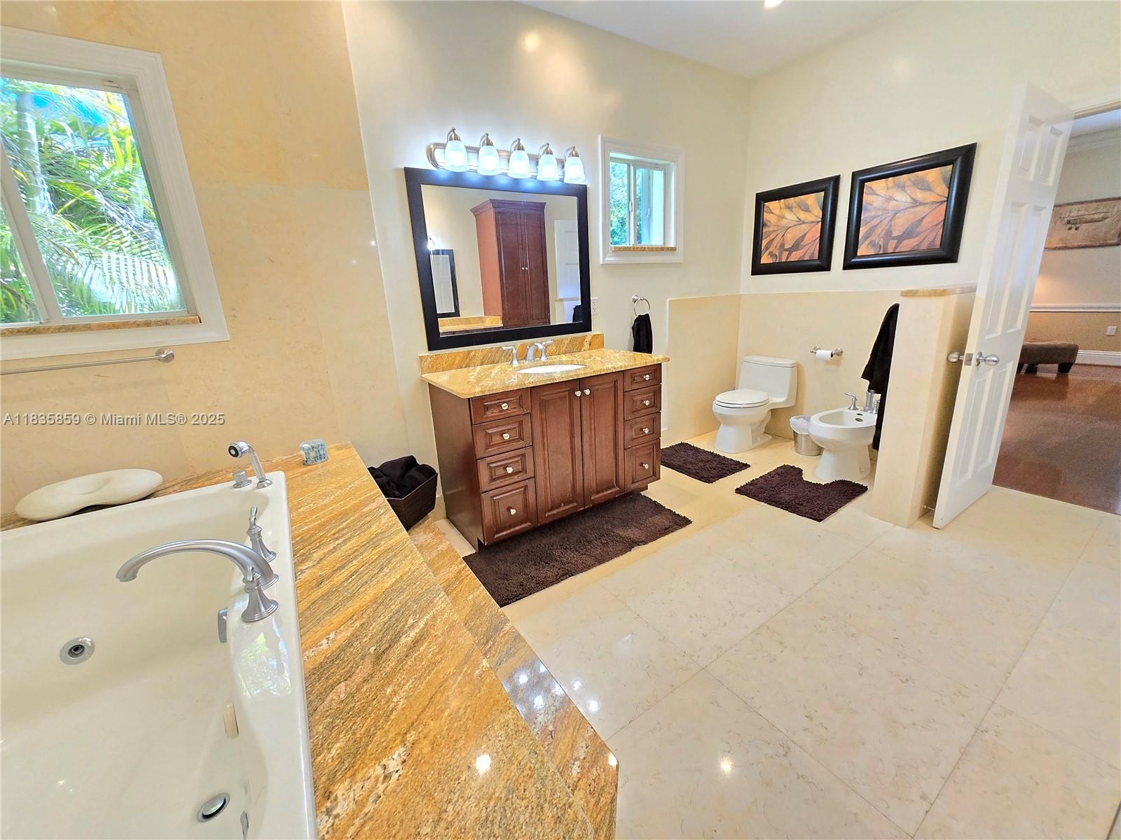 7895 Southwest 122nd Street Pinecrest, FL 33156 - Photo 25 of 78 a living room with furniture and a flat screen tv