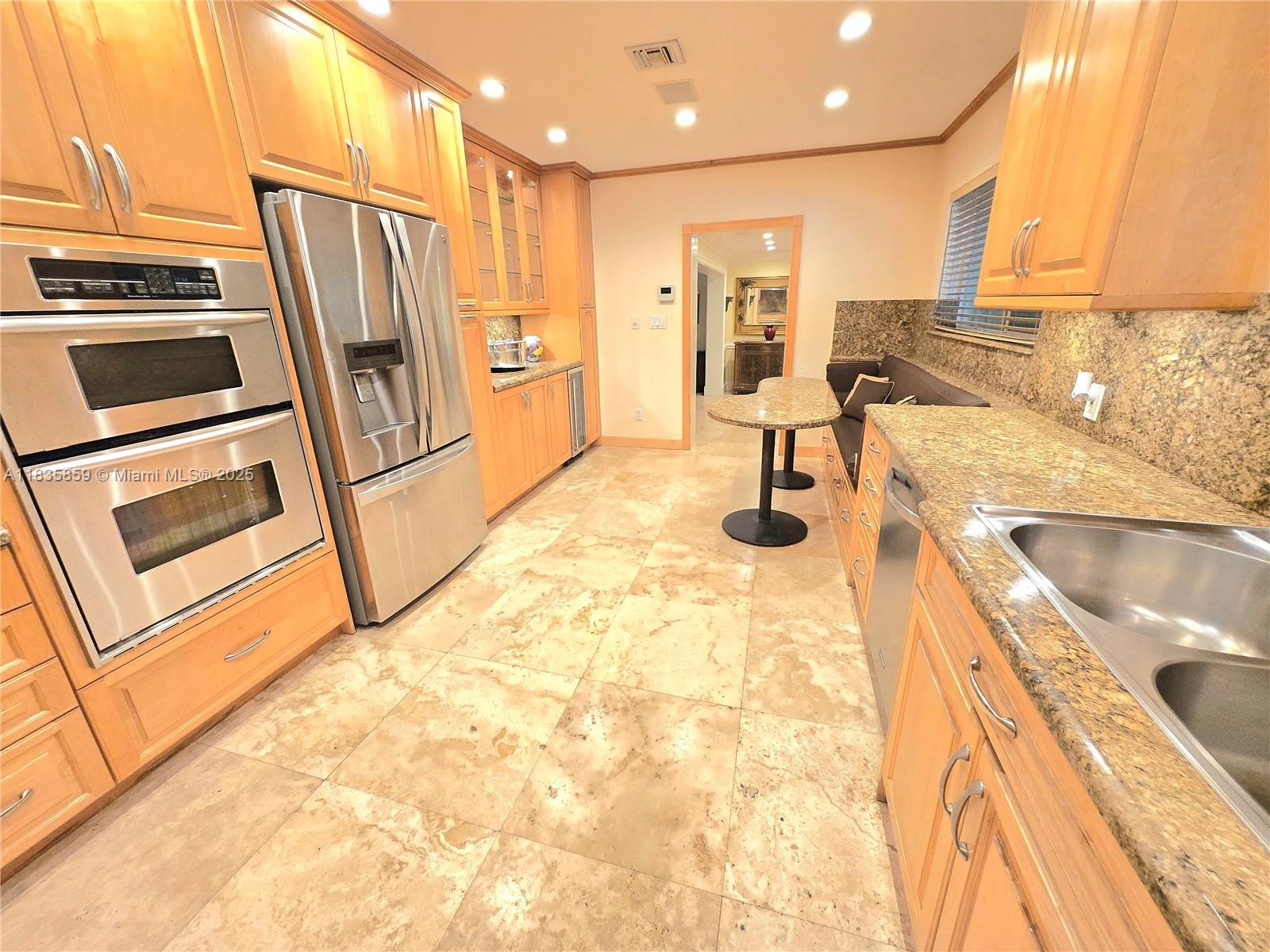 7895 Southwest 122nd Street Pinecrest, FL 33156 - Photo 35 of 78 a kitchen with stainless steel appliances a stove a sink and a refrigerator