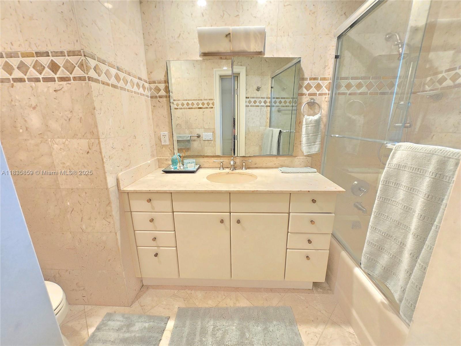 7895 Southwest 122nd Street Pinecrest, FL 33156 - Photo 42 of 78 a bathroom with a sink and a mirror