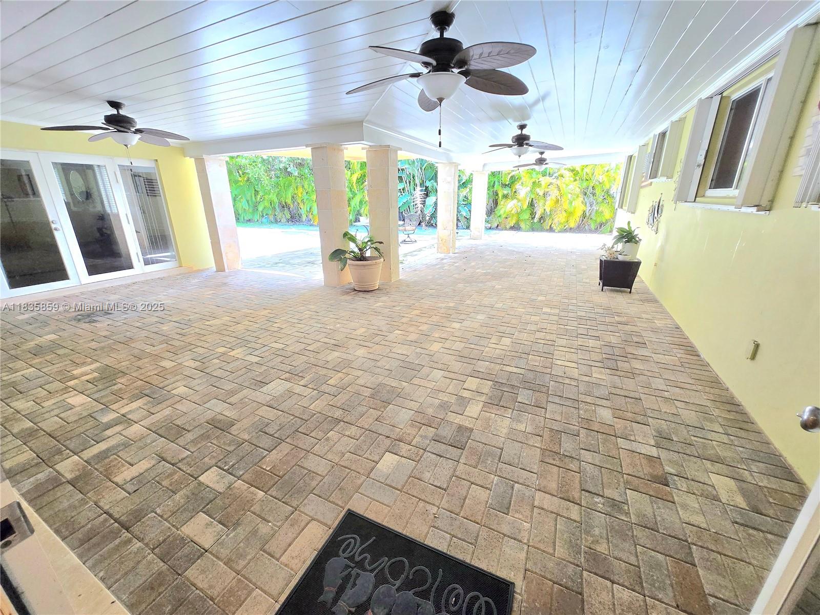 7895 Southwest 122nd Street Pinecrest, FL 33156 - Photo 58 of 78 a view of an entryway with a chandelier