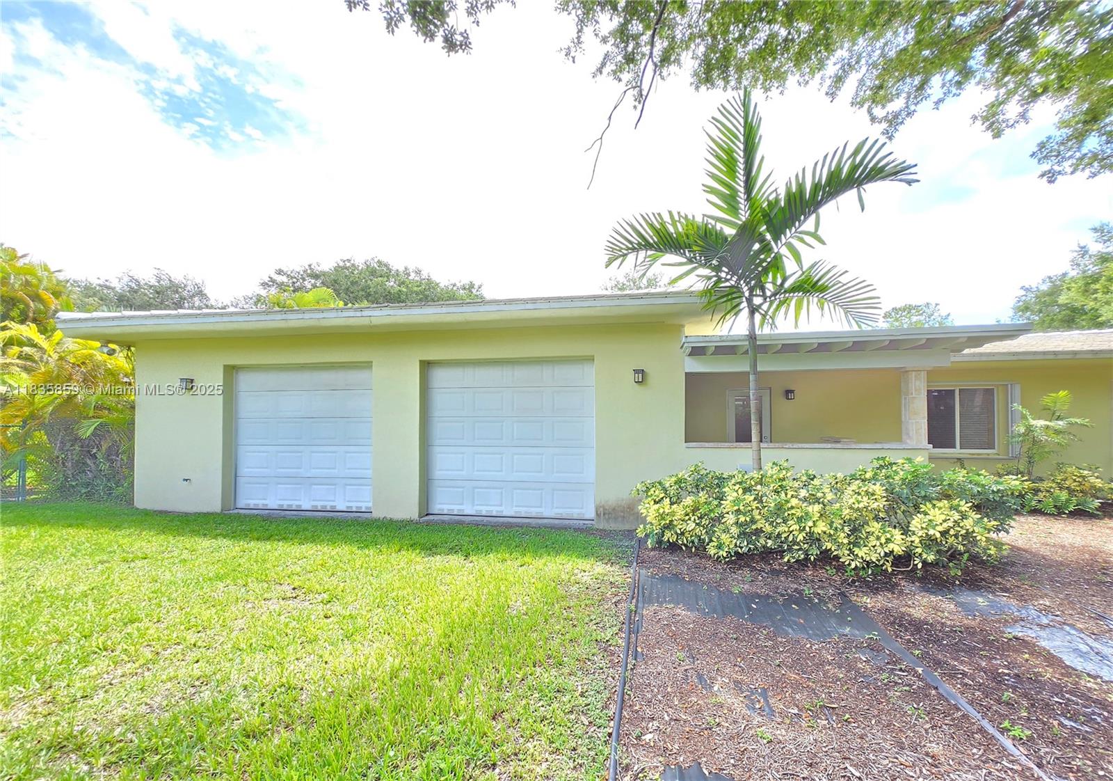 7895 Southwest 122nd Street Pinecrest, FL 33156 - Photo 75 of 78 a front view of a house with garden