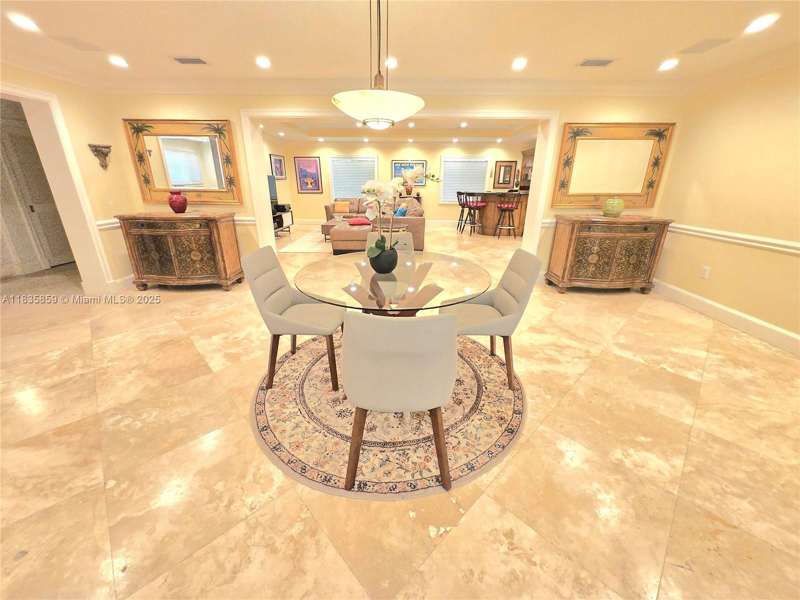 7895 Southwest 122nd Street Pinecrest, FL 33156 - Photo 9 of 78 a view of a kitchen with granite countertop a stove a sink a dining table and chairs