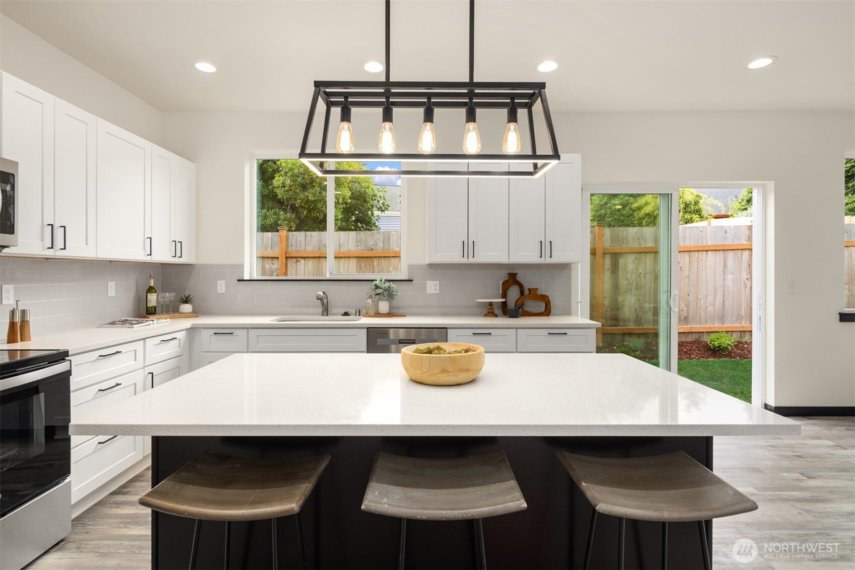 9245 Kelsey Lane Southwest Seattle, WA 98106 - Photo 12 of 33 a kitchen with a sink a stove a window cabinets and dining table