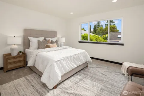 a bedroom with bed and a large mirror