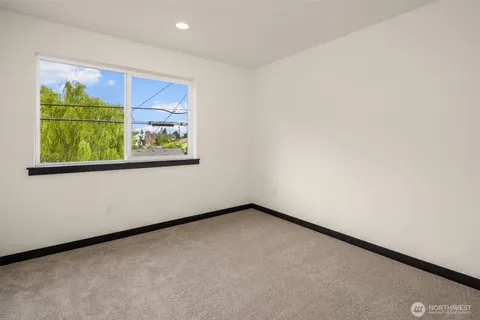 a bathroom with a shower curtain and a window