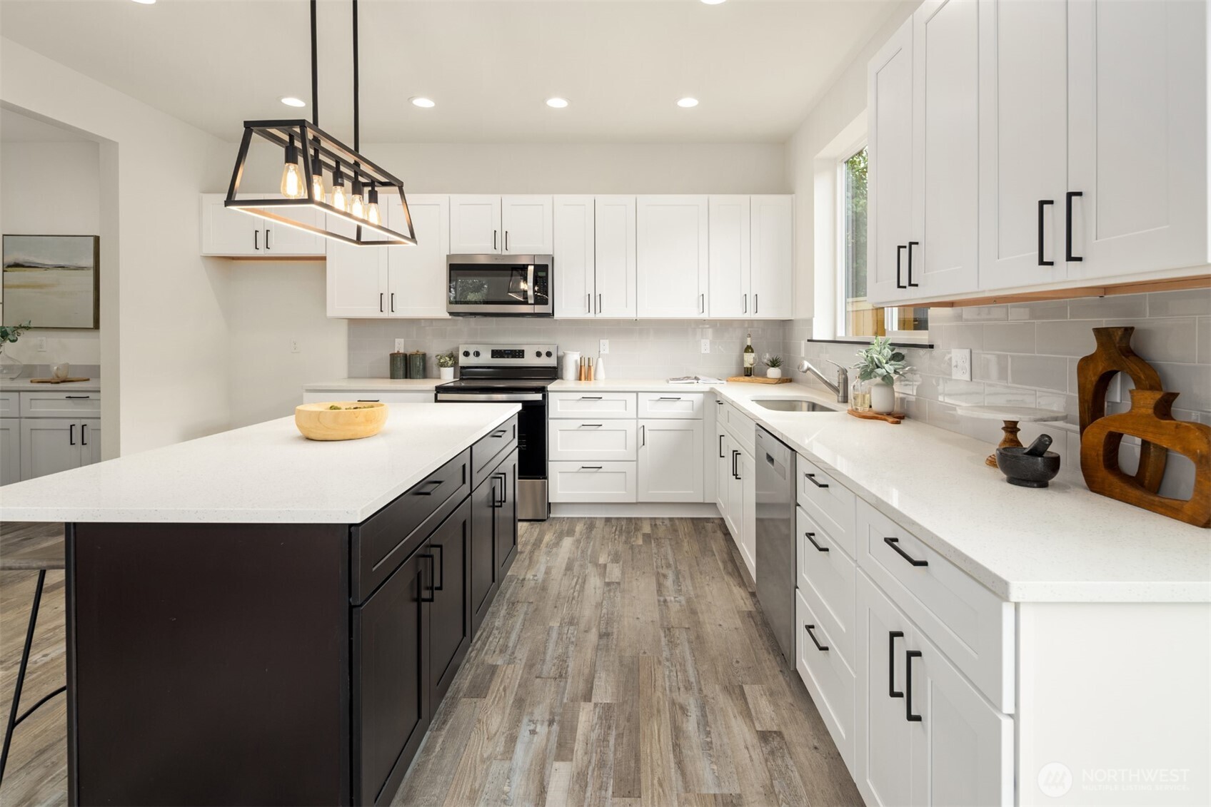 9245 Kelsey Lane Southwest Seattle, WA 98106 - Photo 7 of 33 a kitchen with stainless steel appliances a sink a stove top oven a counter space and cabinets