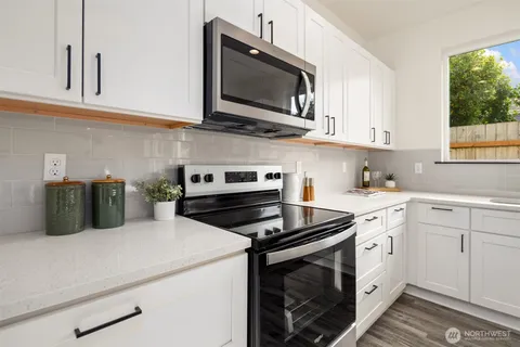 a kitchen with cabinets stainless steel appliances and a sink