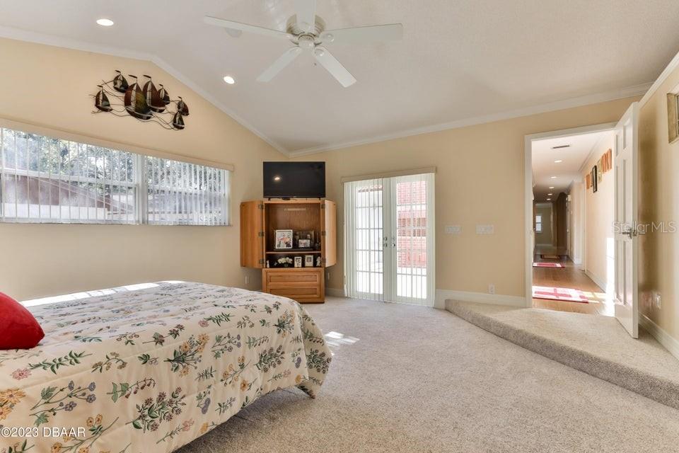4895 Sailfish Drive Ponce Inlet, FL 32127 - Photo 15 of 34 a bedroom with a large bed and a window