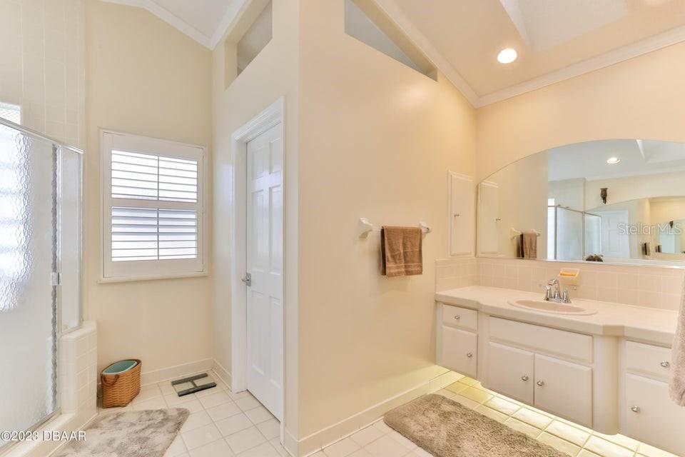 4895 Sailfish Drive Ponce Inlet, FL 32127 - Photo 16 of 34 a spacious bathroom with a sink double vanity and a mirror