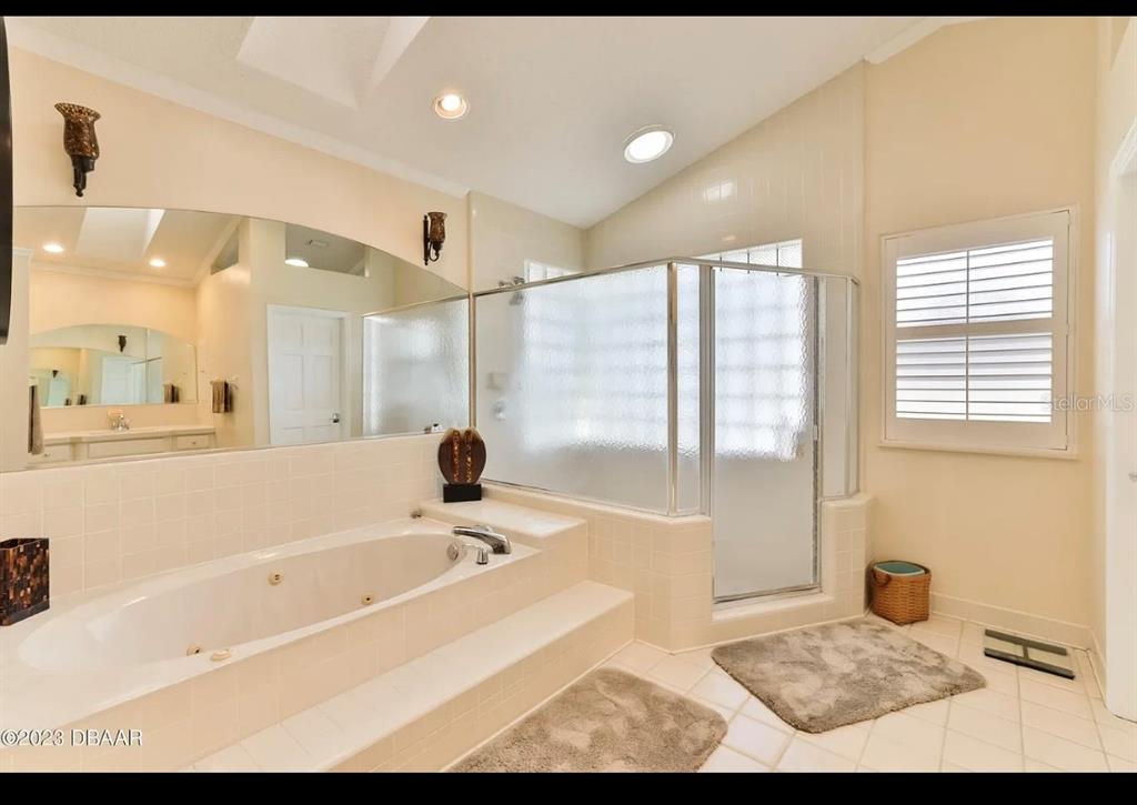 4895 Sailfish Drive Ponce Inlet, FL 32127 - Photo 17 of 34 a bathroom with a bathtub and a shower