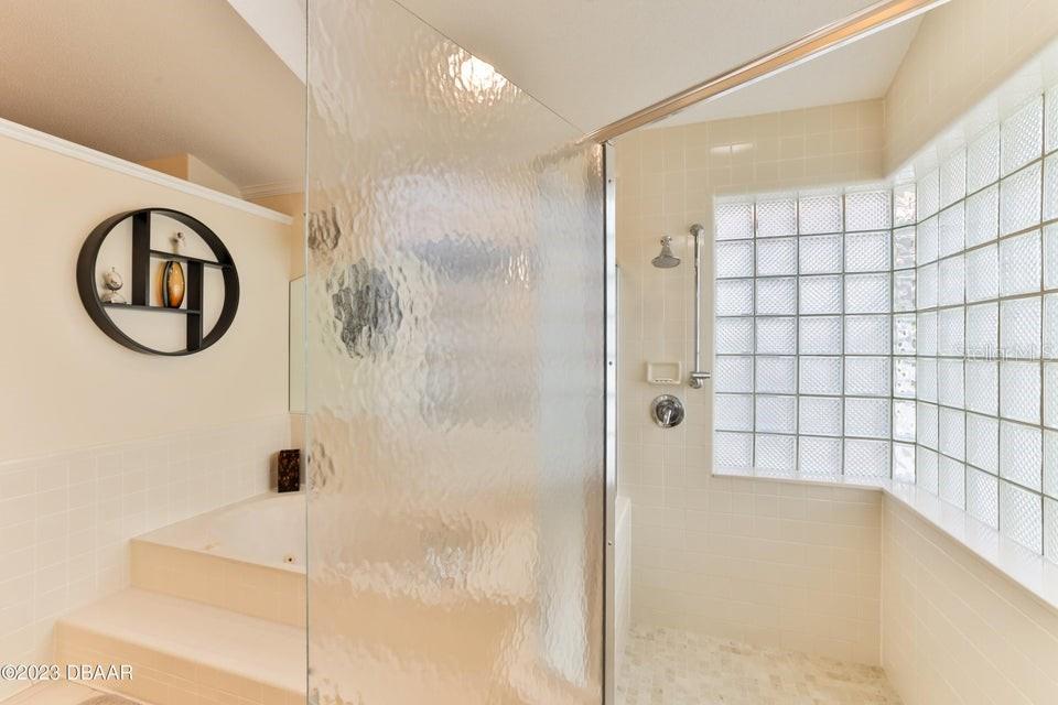 4895 Sailfish Drive Ponce Inlet, FL 32127 - Photo 18 of 34 a bathroom with a bathtub and a shower