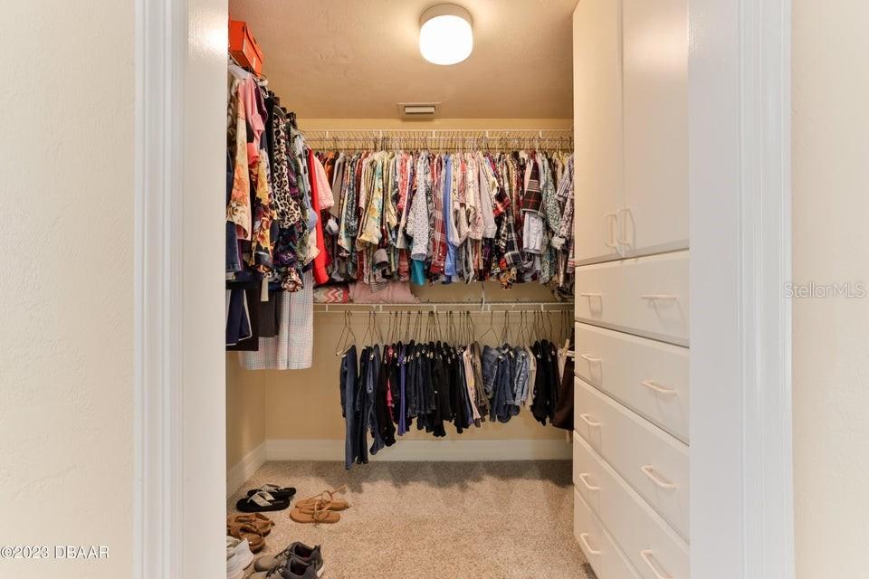4895 Sailfish Drive Ponce Inlet, FL 32127 - Photo 20 of 34 a view of walk in closet with clothes and shoes