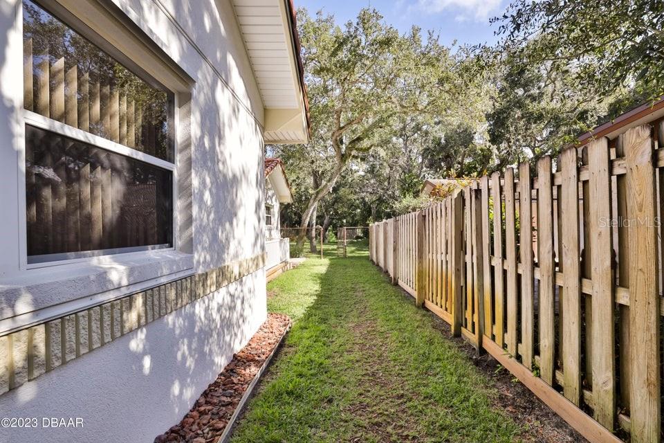 4895 Sailfish Drive Ponce Inlet, FL 32127 - Photo 23 of 34 a view of a yard with wooden fence