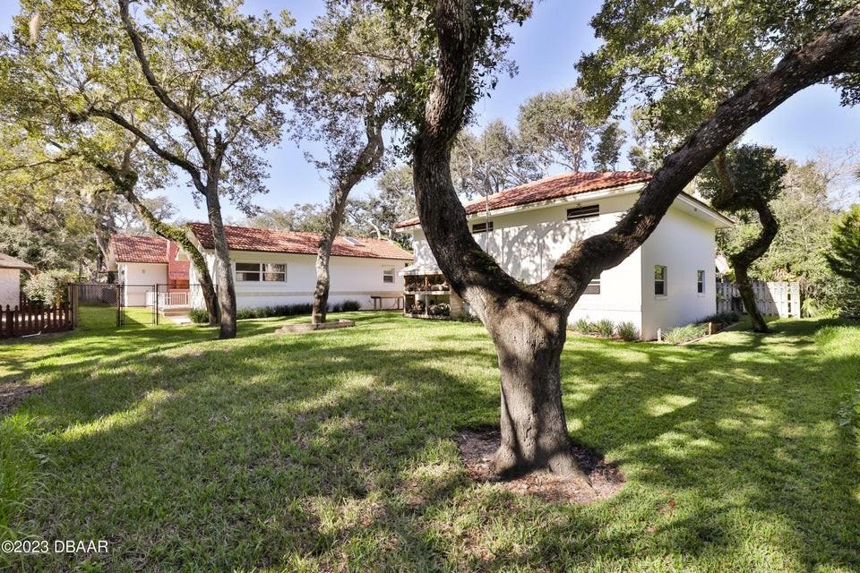 4895 Sailfish Drive Ponce Inlet, FL 32127 - Photo 25 of 34 a view of a house with a yard