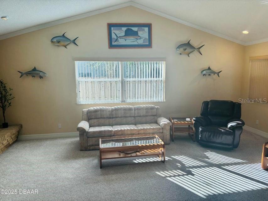 4895 Sailfish Drive Ponce Inlet, FL 32127 - Photo 9 of 34 a sitting area with furniture and a window