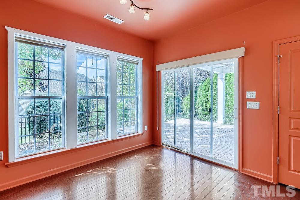 564 Tomkins Loop Cary, NC 27519 - Photo 11 of 28 a view of a room with wooden floor and windows