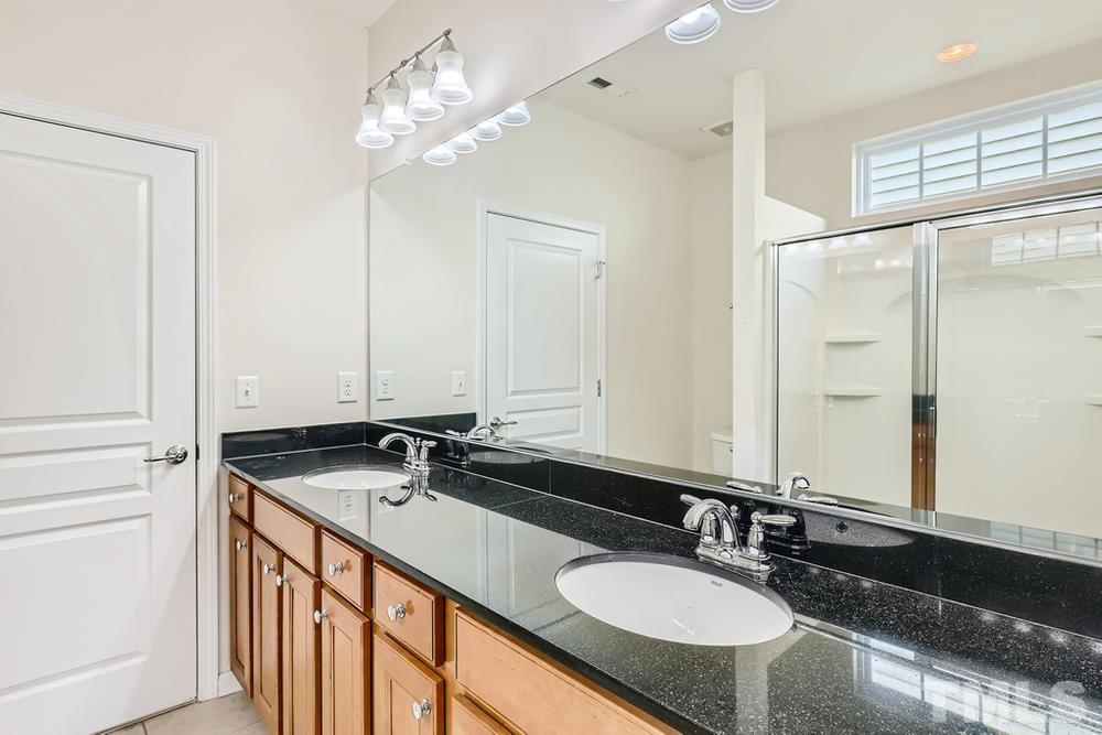 564 Tomkins Loop Cary, NC 27519 - Photo 18 of 28 a bathroom with double sink and a mirror