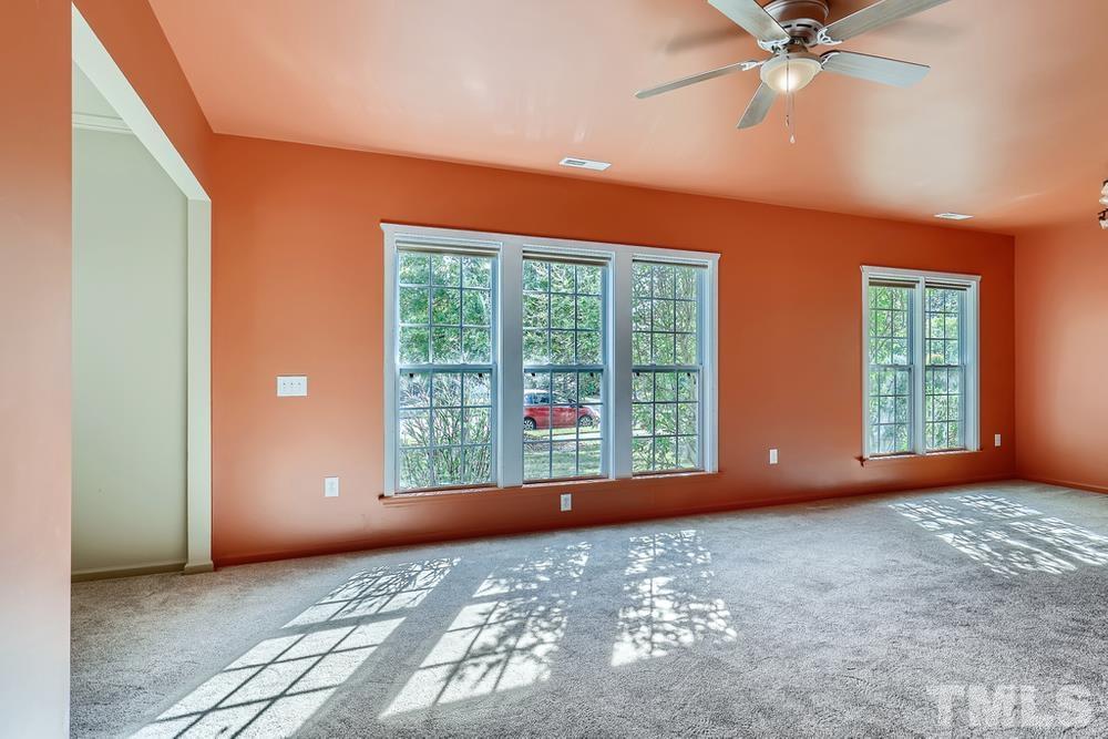 564 Tomkins Loop Cary, NC 27519 - Photo 5 of 28 a view of a livingroom with a ceiling fan and window