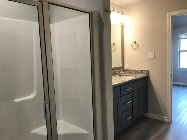 a bathroom with a shower and a mirror
