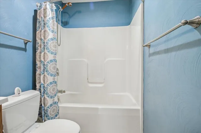 a view of storage and utility room with racks on the wall