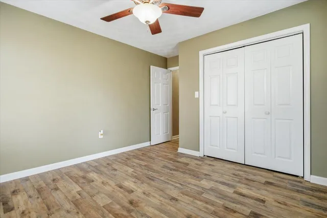 a front view of a house with a garden and yard