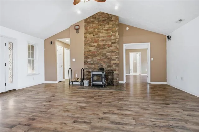 a view of a livingroom with wooden floor and a ceiling fan