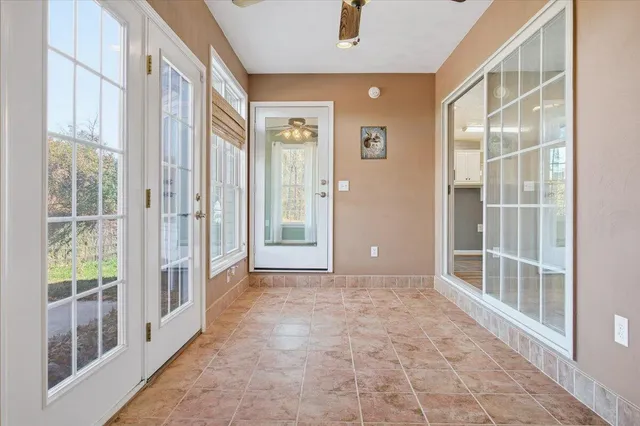 a kitchen with white cabinets and refrigerator